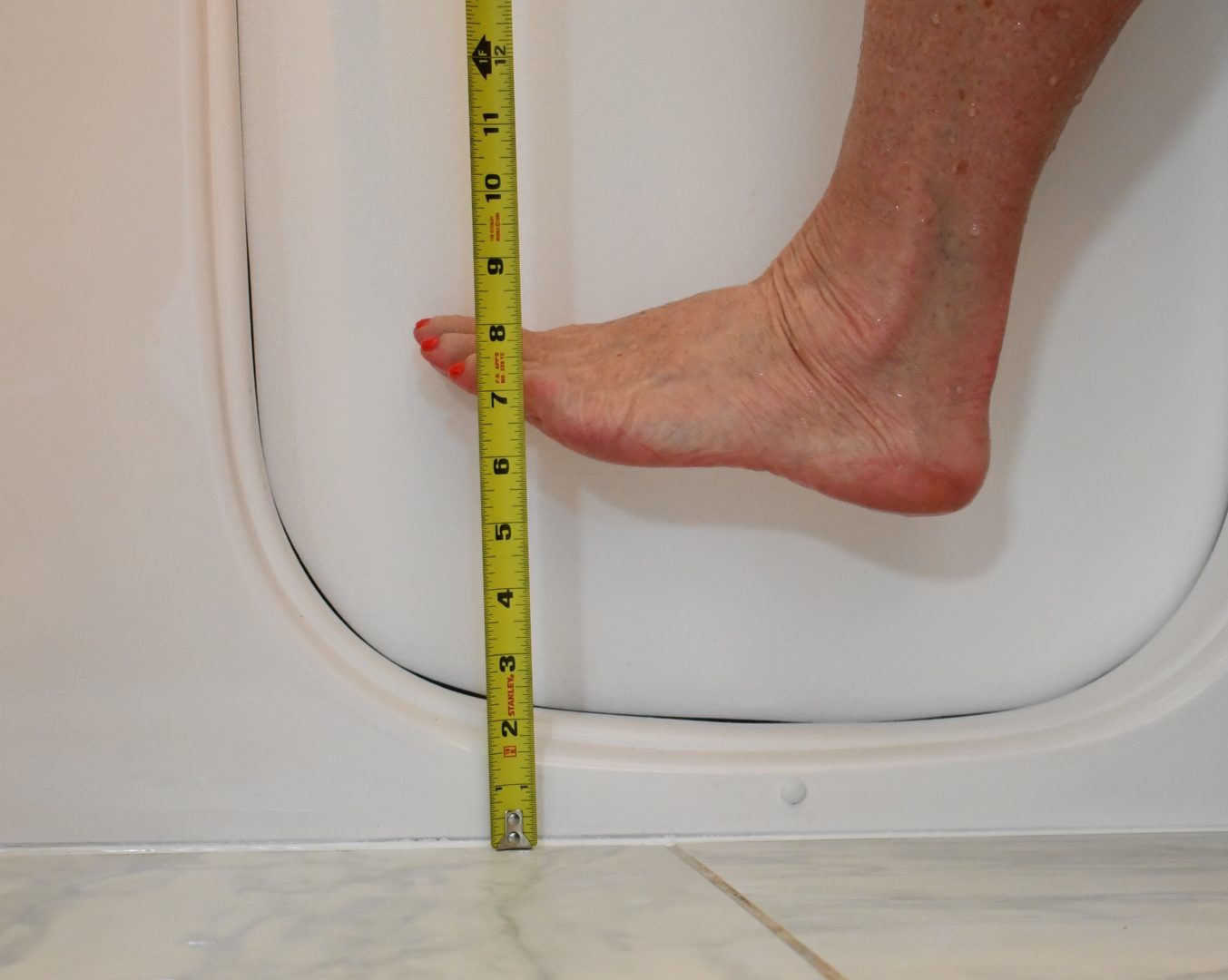 woman walking over low step clearance tub